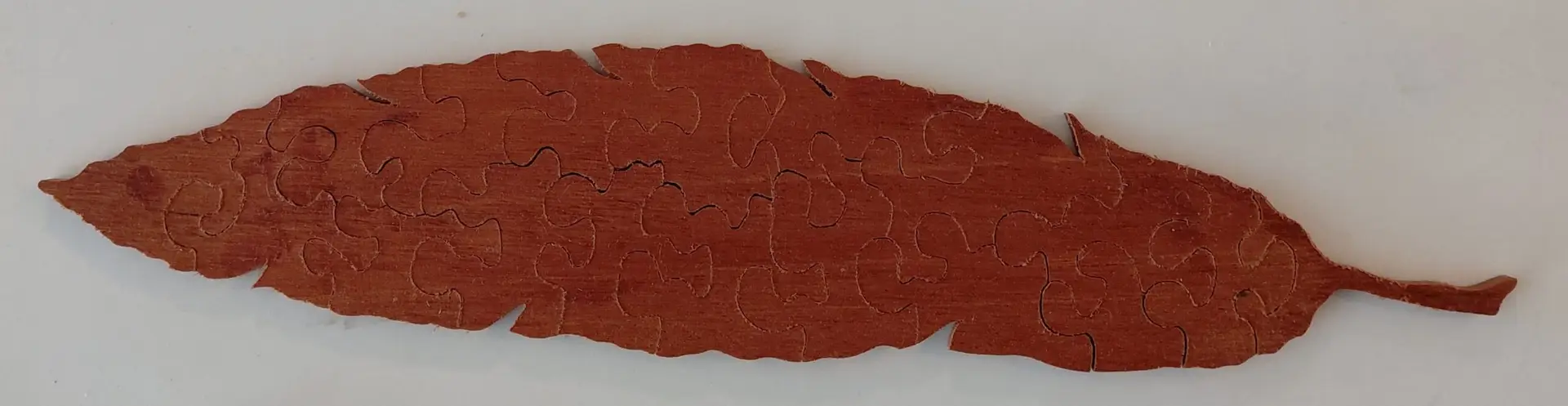 hand crafted wooden jigsaw puzzle feather